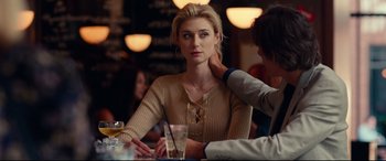Movie still from “Widows” (2018), directed by Steve McQueen – A woman sitting at a table in front of a glass of water; Close Up shot, Over the shoulder angle