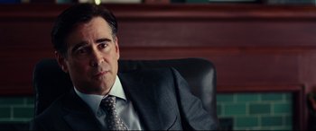 Movie still from “Widows” (2018), directed by Steve McQueen – A person wearing a suit and tie; Close Up shot, Over the shoulder angle