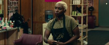 Movie still from “Widows” (2018), directed by Steve McQueen – A woman in an apron standing in front of a counter; Medium shot, Over the shoulder angle