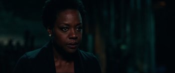 Movie still from “Widows” (2018), directed by Steve McQueen – A black woman with short black hair is looking at the camera; Close Up shot, Over the shoulder angle
