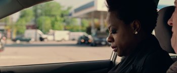 Movie still from “Widows” (2018), directed by Steve McQueen – A woman sitting in the passenger seat of a car looking out the window; Close Up shot, Over the shoulder angle
