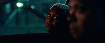 Movie still from “Widows” (2018), directed by Steve McQueen – A woman sitting in a car looking out the window at night; Close Up shot, Over the shoulder angle