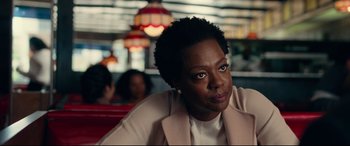 Movie still from “Widows” (2018), directed by Steve McQueen – A woman sitting at a table in a restaurant; Close Up shot, Over the shoulder angle