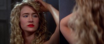 Movie still from “Wild at Heart” (1990), directed by David Lynch – A woman with red lipstick looking in a mirror; Close Up shot, Over the shoulder angle