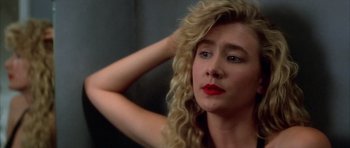 Movie still from “Wild at Heart” (1990), directed by David Lynch – A woman with blonde hair and red lipstick looking to her left; Close Up shot, Over the shoulder angle