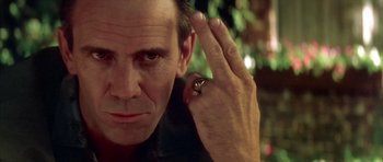 Movie still from “Wild at Heart” (1990), directed by David Lynch – A person with a ring on his finger; Close Up shot, Low angle