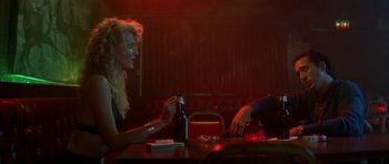 Movie still from “Wild at Heart” (1990), directed by David Lynch – A woman sitting at a table with a man; Medium shot, Over the shoulder angle