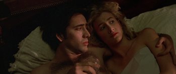 Movie still from “Wild at Heart” (1990), directed by David Lynch – A man and a woman laying in bed together; Close Up shot, Overhead angle