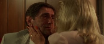 Movie still from “Wild at Heart” (1990), directed by David Lynch – A man and a woman looking in the same mirror; Close Up shot, Over the shoulder angle