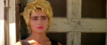 Movie still from “Wild at Heart” (1990), directed by David Lynch – A woman with blonde hair and pink lipstick; Close Up shot, High angle