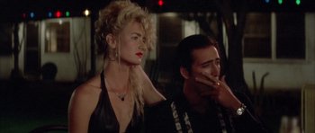 Movie still from “Wild at Heart” (1990), directed by David Lynch – A man and a woman sitting next to each other; Close Up shot, Low angle