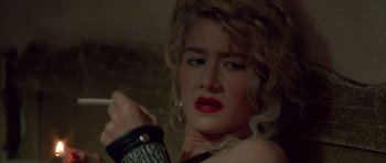 Movie still from “Wild at Heart” (1990), directed by David Lynch – A person with a hand on a wrist; Close Up shot, Over the shoulder angle