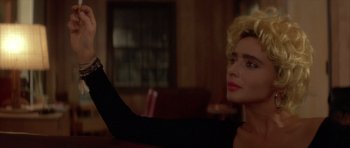 Movie still from “Wild at Heart” (1990), directed by David Lynch – A woman sitting at a table in front of a window; Close Up shot, Over the shoulder angle