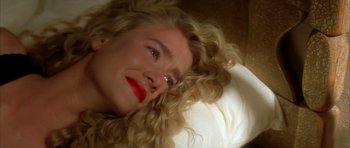 Movie still from “Wild at Heart” (1990), directed by David Lynch – A woman laying in bed with her eyes closed; Close Up shot, Overhead angle