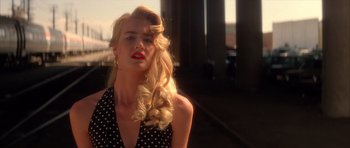 Movie still from “Wild at Heart” (1990), directed by David Lynch – A blonde woman with long blonde hair wearing a polka dot dress; Close Up shot, Low angle