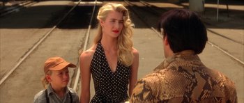 Movie still from “Wild at Heart” (1990), directed by David Lynch – A woman in a polka dot dress talking to a man in a snake skin jacket; Close Up shot, Over the shoulder angle
