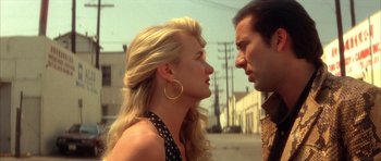 Movie still from “Wild at Heart” (1990), directed by David Lynch – A man and a woman standing next to each other on the street; Close Up shot, Low angle