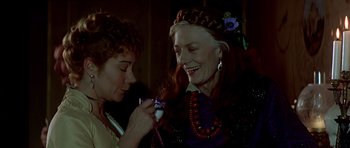Movie still from “Wilde” (1997), directed by Brian Gilbert – Two women are smiling and one is holding a cell phone; Close Up shot, Over the shoulder angle