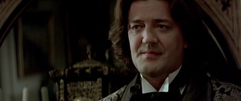 Movie still from “Wilde” (1997), directed by Brian Gilbert – A person with long hair; Close Up shot, Low angle