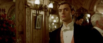 Movie still from “Wilde” (1997), directed by Brian Gilbert – A young man in a tuxedo standing in front of a mirror; Medium shot, Low angle