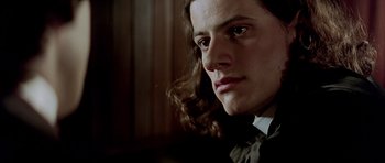 Movie still from “Wilde” (1997), directed by Brian Gilbert – A person with long hair; Close Up shot, Low angle