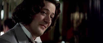 Movie still from “Wilde” (1997), directed by Brian Gilbert – A person with long brown hair; Close Up shot, Over the shoulder angle