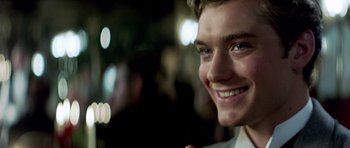 Movie still from “Wilde” (1997), directed by Brian Gilbert – A person smiling at the camera; Close Up shot, Over the shoulder angle