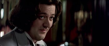 Movie still from “Wilde” (1997), directed by Brian Gilbert – A person with long hair; Close Up shot, Over the shoulder angle