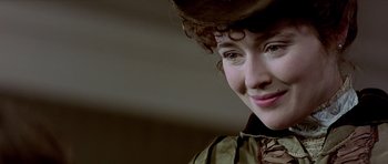 Movie still from “Wilde” (1997), directed by Brian Gilbert – A person wearing a hat; Close Up shot, Over the shoulder angle