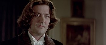 Movie still from “Wilde” (1997), directed by Brian Gilbert – A person with long hair; Close Up shot, Low angle