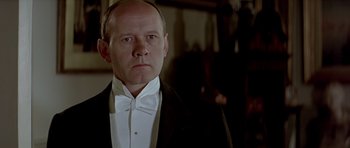Movie still from “Wilde” (1997), directed by Brian Gilbert – A man wearing a tuxedo and a bow tie; Close Up shot, Low angle