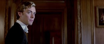 Movie still from “Wilde” (1997), directed by Brian Gilbert – A young man with blonde hair and blue eyes looking into a mirror; Close Up shot, Low angle