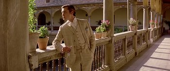 Movie still from “Wilde” (1997), directed by Brian Gilbert – A man in a suit and tie holding a key; Medium shot, Low angle