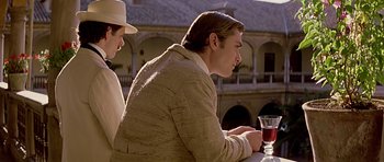 Movie still from “Wilde” (1997), directed by Brian Gilbert – A man and a woman sitting at an outdoor table; Medium shot, Over the shoulder angle