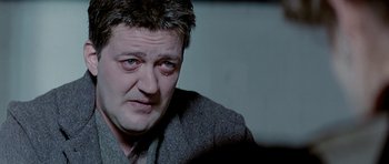 Movie still from “Wilde” (1997), directed by Brian Gilbert – A person wearing a jacket; Close Up shot, Low angle