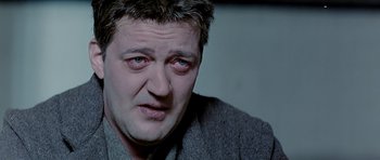 Movie still from “Wilde” (1997), directed by Brian Gilbert – A person wearing a jacket; Close Up shot, High angle