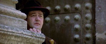 Movie still from “Wilde” (1997), directed by Brian Gilbert – A man wearing a hat and a coat; Close Up shot, Low angle
