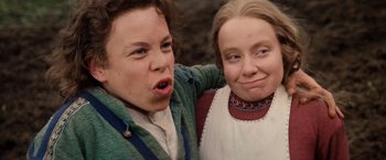 Movie still from “Willow” (1988), directed by Ron Howard – Two young people are posing for a picture; Close Up shot, High angle