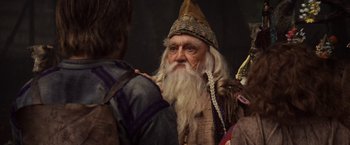 Movie still from “Willow” (1988), directed by Ron Howard – An old man with a beard and a long white beard; Close Up shot, Over the shoulder angle