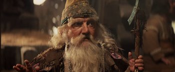 Movie still from “Willow” (1988), directed by Ron Howard – An old man with long white hair and a long beard; Close Up shot, Low angle