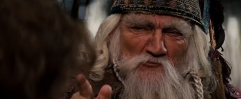 Movie still from “Willow” (1988), directed by Ron Howard – An old man with long white hair and a beard; Close Up shot, Over the shoulder angle