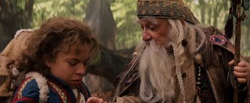Movie still from “Willow” (1988), directed by Ron Howard – An old man and a young boy looking at something; Close Up shot, High angle