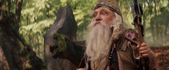 Movie still from “Willow” (1988), directed by Ron Howard – An old man with long white hair and a beard; Close Up shot, Low angle