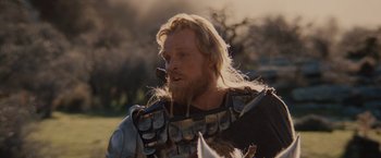 Movie still from “Willow” (1988), directed by Ron Howard – A person with a beard wearing armor; Close Up shot, Low angle