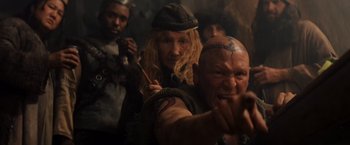 Movie still from “Willow” (1988), directed by Ron Howard – A group of people standing next to each other in a room; Close Up shot, High angle