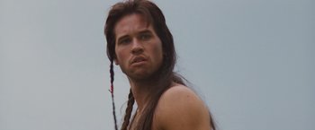 Movie still from “Willow” (1988), directed by Ron Howard – A person with long brown hair; Close Up shot, Low angle