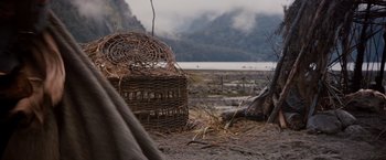 Movie still from “Willow” (1988), directed by Ron Howard – A basket in the middle of a field; Medium shot, High angle