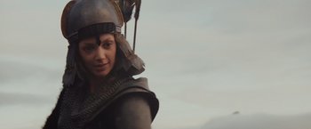 Movie still from “Willow” (1988), directed by Ron Howard – A woman wearing a helmet and holding a spear; Close Up shot, Low angle