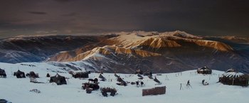 Movie still from “Willow” (1988), directed by Ron Howard – A view of a mountain range with snow on the ground; Extreme Wide shot, High angle