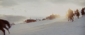 Movie still from “Willow” (1988), directed by Ron Howard – A snow covered field with tents on top of it; Extreme Wide shot, Low angle